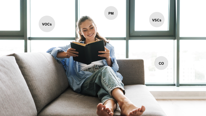 Woman sitting on couch with air around her